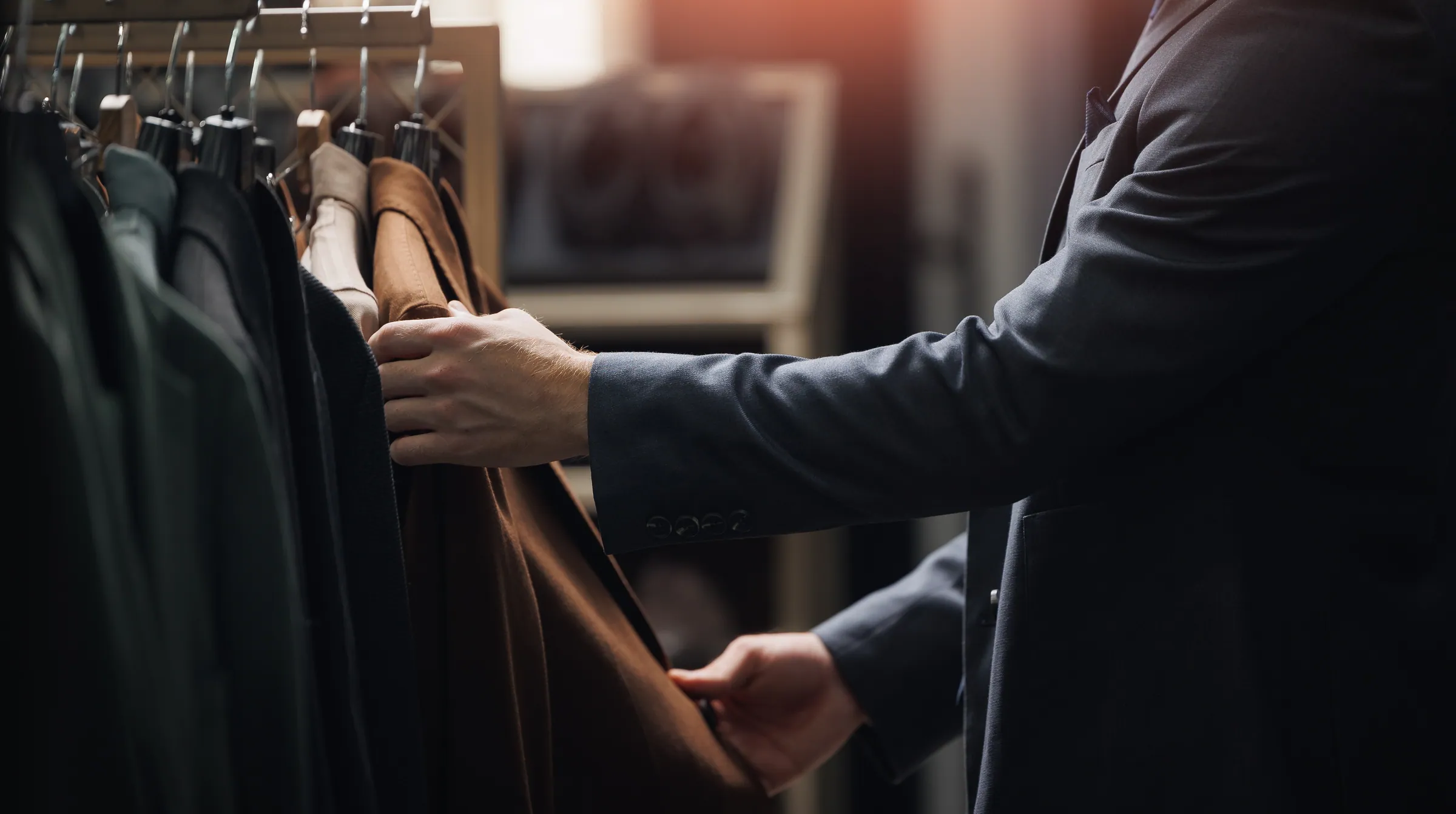 Master tailor selecting suits inside the Westbury atelier